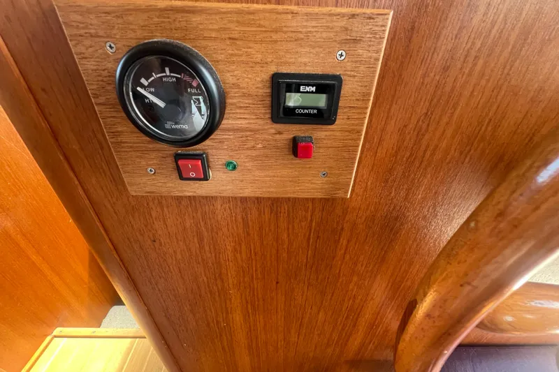 Slide: The Image of 2001 Mainship 390 Trawler control panel with gauge and switches on wooden surface. - 10
