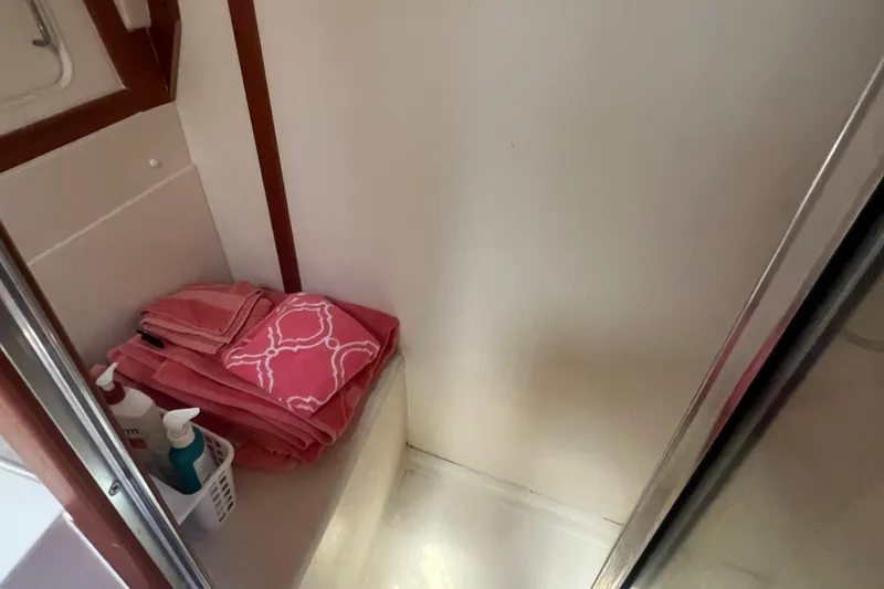 Slide: The Image of 2001 Mainship 390 Trawler bathroom with pink towels and toiletries. - 18