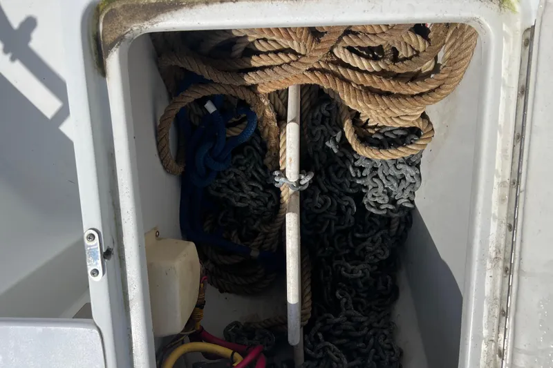 Slide: The Image of Anchor locker with ropes and chains on a 2001 Mainship 390 Trawler. - 24