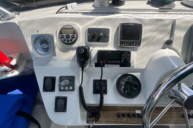 Slide: The Image of Control panel of a 2001 Mainship 390 Trawler with navigation and communication equipment. - 29