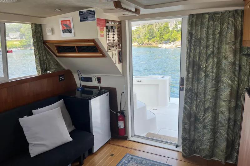 Slide: The Image of Interior of 2001 Mainship 390 Trawler with view of water through open door. - 3