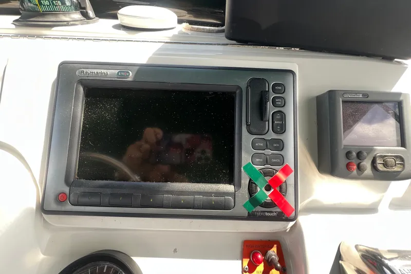 Slide: The Image of 2001 Mainship 390 Trawler dashboard with Raymarine navigation system and controls. - 31