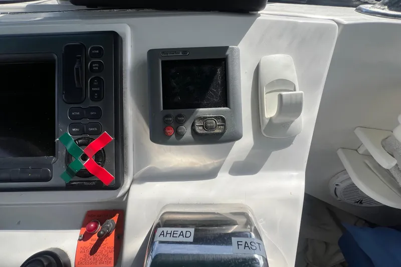 Slide: The Image of 2001 Mainship 390 Trawler dashboard with navigation controls and speed settings. - 32