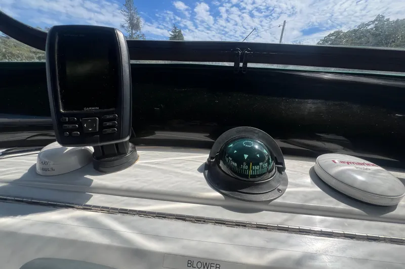 Slide: The Image of Dashboard of 2001 Mainship 390 Trawler with Garmin device and compass under blue sky. - 33
