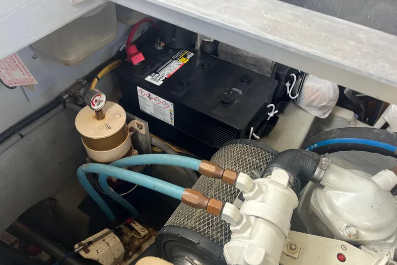 Slide: The Image of Engine compartment of 2001 Mainship 390 Trawler with battery and fuel filter system. - 34