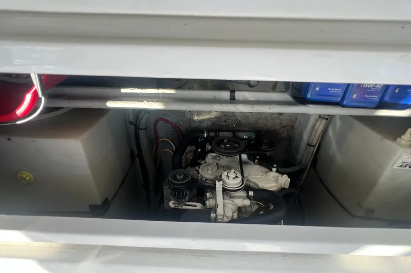 Slide: The Image of Engine compartment of a 2001 Mainship 390 Trawler, showcasing mechanical components and storage. - 35