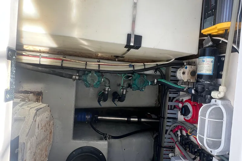 Slide: The Image of Engine room of a 2001 Mainship 390 Trawler, showcasing mechanical components and wiring. - 37