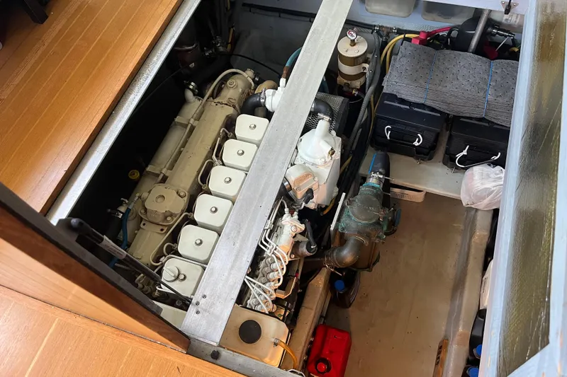 Slide: The Image of Engine room of 2001 Mainship 390 Trawler, showcasing mechanical components and storage. - 39