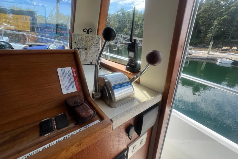 Slide: The Image of 2001 Mainship 390 Trawler helm with throttle controls and marine radio. - 7