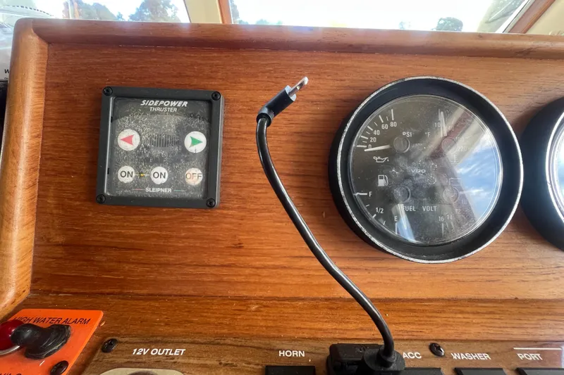 Slide: The Image of Control panel of a 2001 Mainship 390 Trawler with gauges and thruster controls. - 9