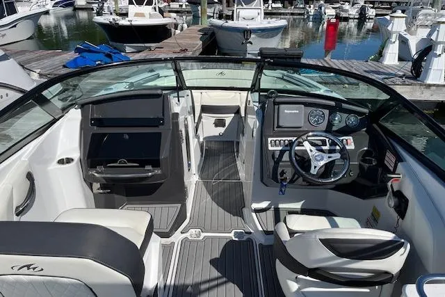 Slide: The Image of 2017 Monterey M-45 boat interior with steering wheel, dashboard, and seating at marina. - 14