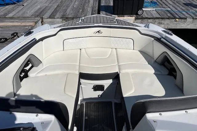 Slide: The Image of 2017 Monterey M-45 boat interior with white seating and sleek design at a dock. - 19