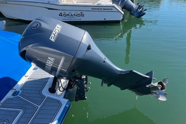 Slide: The Image of Outboard motor on a 2017 Monterey M-45 boat, docked near a Grady-White vessel. - 3