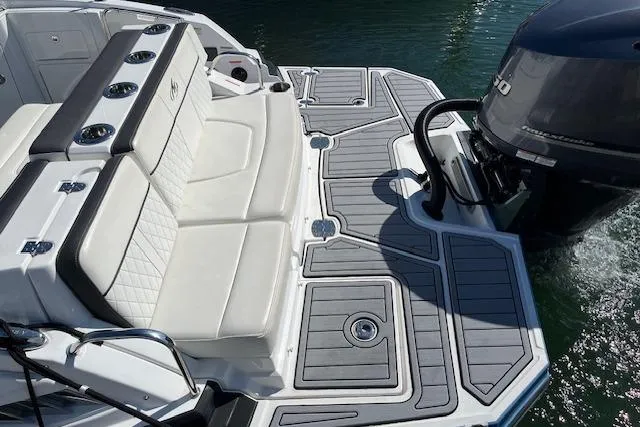 Slide: The Image of 2017 Monterey M-45 boat with cushioned seating and outboard motor on water. - 5