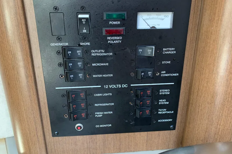 Slide: The Image of Electrical control panel of a 2013 Sea Ray 240 Sundancer boat, featuring various switches and indicators. - 10