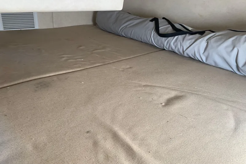 Slide: The Image of Interior cabin of 2013 Sea Ray 240 Sundancer with rolled-up cover. - 14