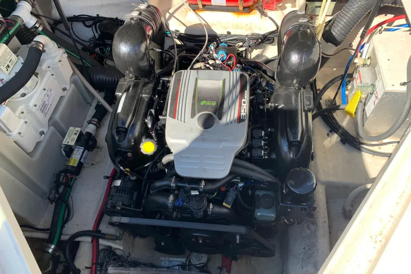 Slide: The Image of Engine compartment of a 2013 Sea Ray 240 Sundancer boat, featuring a 350 MAG engine. - 15