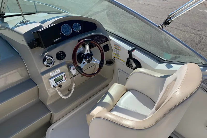 Slide: The Image of 2013 Sea Ray 240 Sundancer helm with steering wheel, gauges, and control panel. - 3