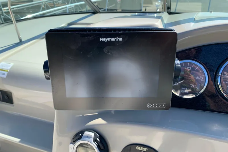 Slide: The Image of Raymarine display on 2013 Sea Ray 240 Sundancer dashboard with gauges and controls. - 5