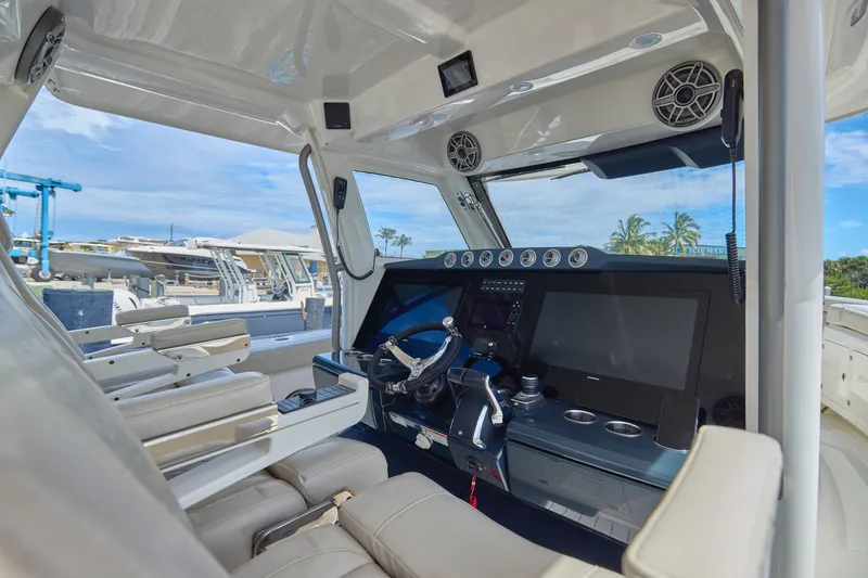 Slide: The Image of Interior of 2022 Solace 41 CS boat, featuring modern helm and seating. - 16