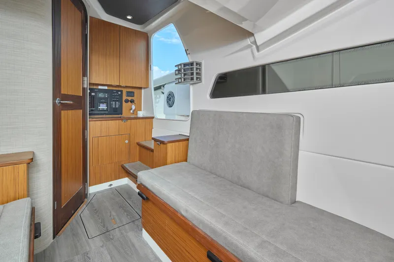 Slide: The Image of Interior of 2022 Solace 41 CS boat with modern wood finish and seating area. - 17