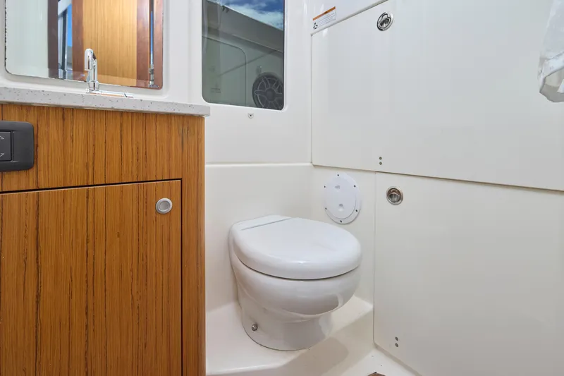 Slide: The Image of 2022 Solace 41 CS boat bathroom with wooden cabinetry and modern fixtures. - 19