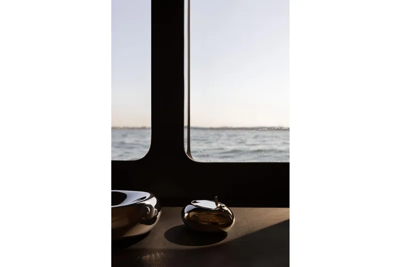 Slide: The Image of Interior view from Moon Yachts 6ty, 2026 model, overlooking serene ocean waters. - 16