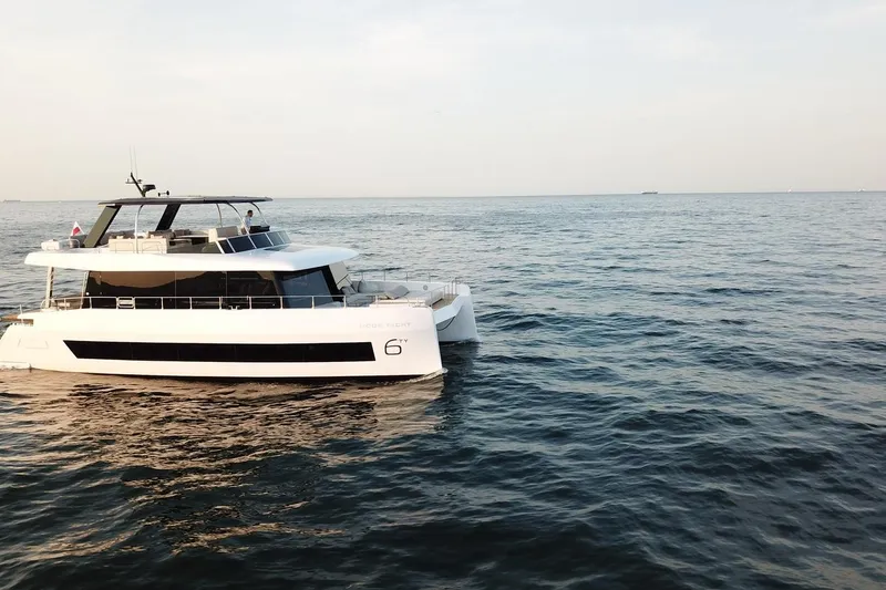 Slide: The Image of 2026 Moon Yachts 6ty cruising on open sea under clear sky. - 27