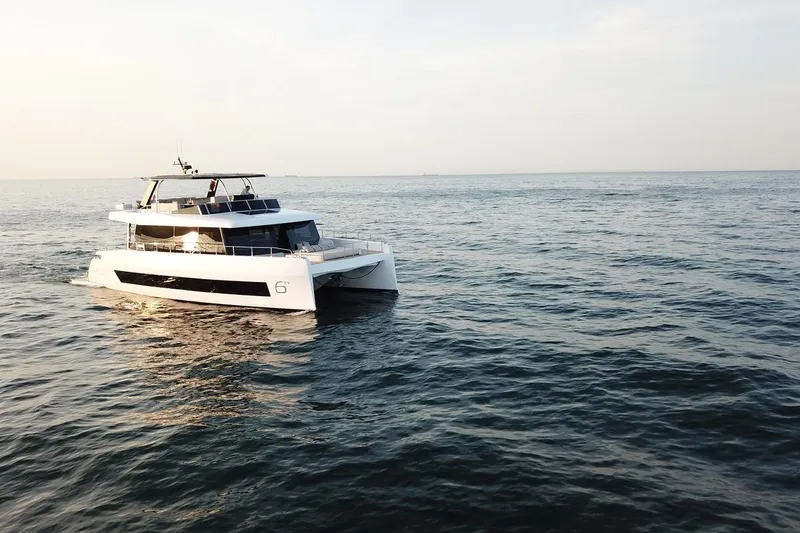 Slide: The Image of 2026 Moon Yachts 6ty sailing on calm ocean waters at sunset. - 29