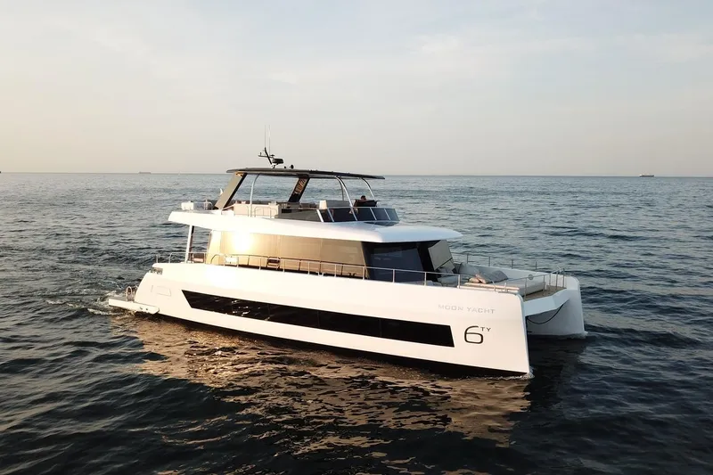 Slide: The Image of Luxury 2026 Moon Yachts 6ty cruising on open sea at sunset. - 33