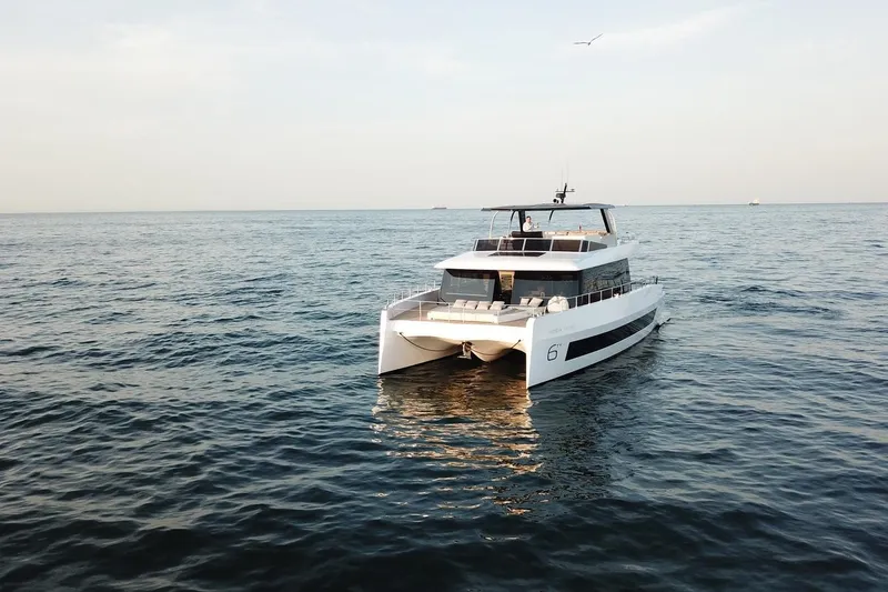 Slide: The Image of Luxury 2026 Moon Yachts 6ty catamaran sailing on open sea. - 35