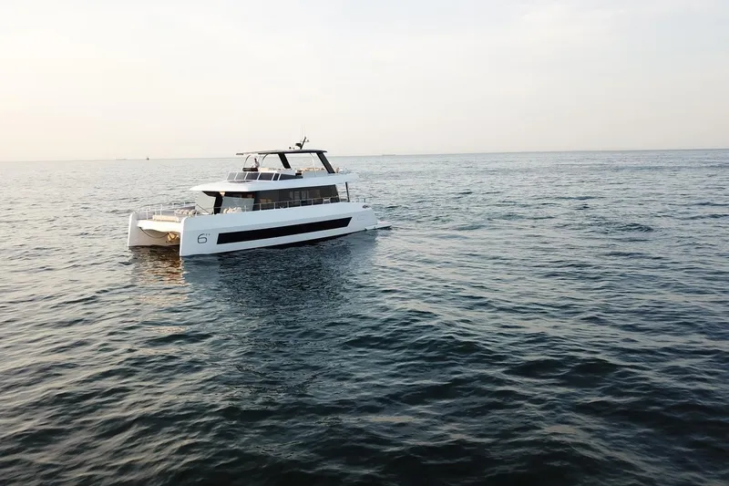 Slide: The Image of Luxury Moon Yachts 6ty 2026 model cruising on open sea at sunset. - 42