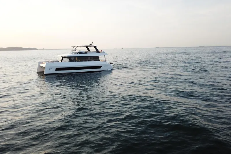 Slide: The Image of Luxury Moon Yachts 6ty 2026 model cruising on serene ocean waters. - 45