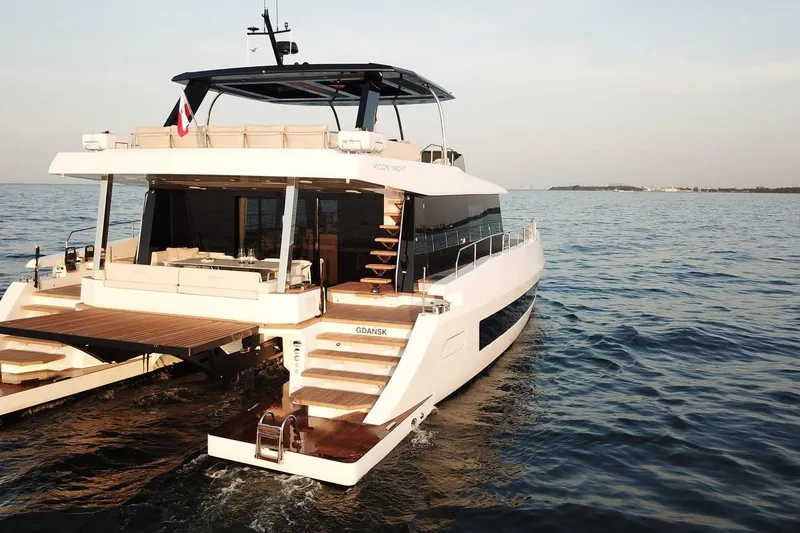Slide: The Image of Luxurious 2026 Moon Yachts 6ty sailing on open water, showcasing elegant design and spacious deck. - 26