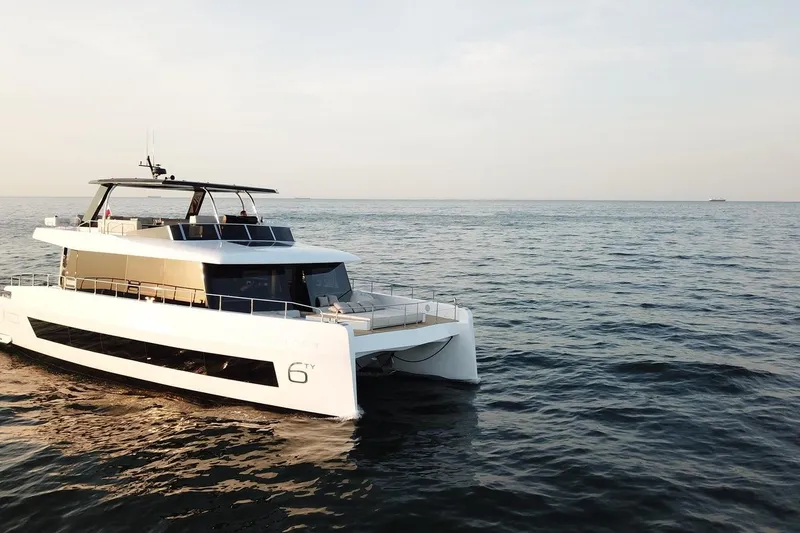 Slide: The Image of 2026 Moon Yachts 6ty luxury yacht cruising on open sea at sunset. - 31