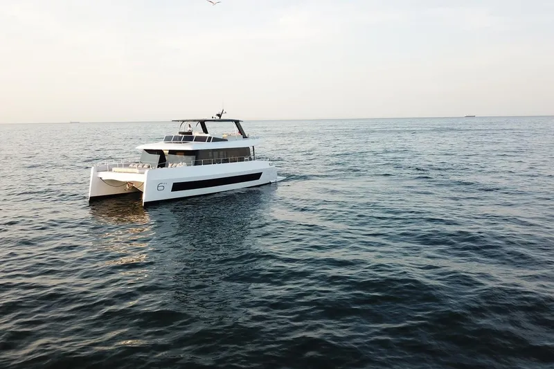 Slide: The Image of Luxury Moon Yachts 6ty 2026 model cruising on open sea under clear sky. - 41