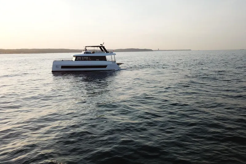 Slide: The Image of Moon Yachts 6ty 2026 sailing on calm sea at sunset. - 48