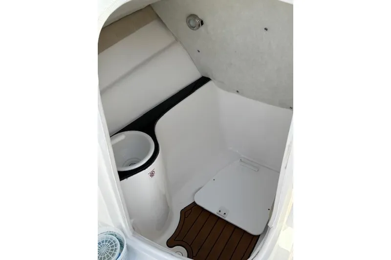 Slide: The Image of 2018 Sea Fox 226 Traveler boat interior with compact restroom and wooden flooring. - 13