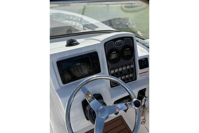 Slide: The Image of 2018 Sea Fox 226 Traveler boat dashboard with steering wheel and control panel. - 14