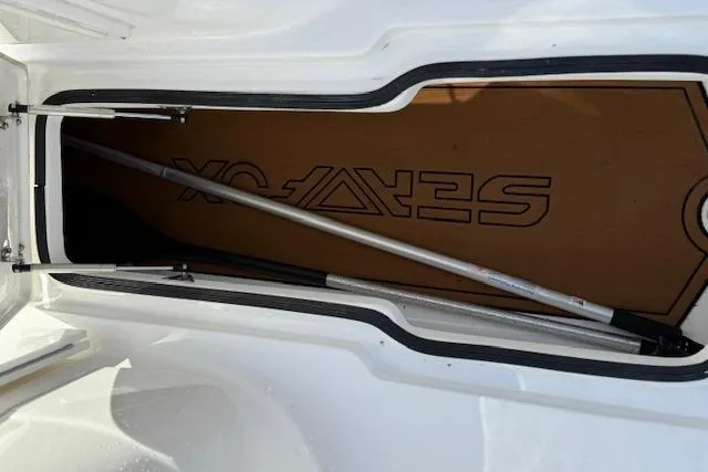 Slide: The Image of Storage compartment of 2018 Sea Fox 226 Traveler boat with visible pole and logo. - 19