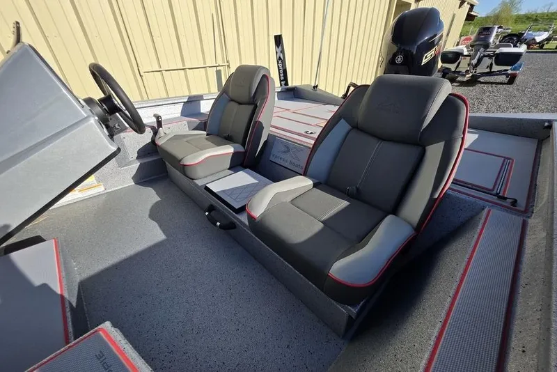 Slide: The Image of 2025 Xpress H18C Crappie boat interior with dual seats and steering console. - 18