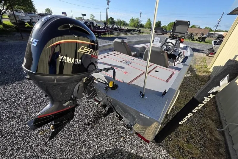 Slide: The Image of 2025 Xpress H18C Crappie boat with Yamaha motor, parked on gravel. - 5
