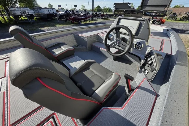 Slide: The Image of 2025 Xpress H18C Crappie boat interior with steering wheel and seating, featuring modern design. - 7