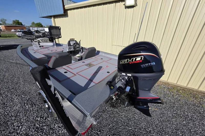 Slide: The Image of 2025 Xpress H18C Crappie boat with Yamaha VMAX engine, parked on gravel. - 8