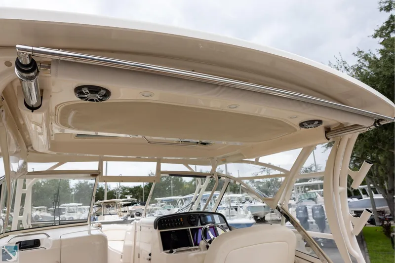 Slide: The Image of 2019 Grady-White Freedom 335 boat interior, featuring helm and seating area. - 14