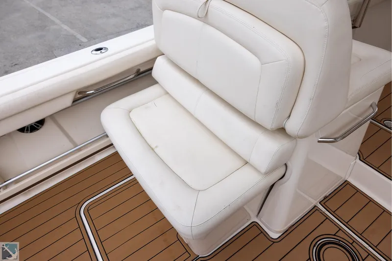 Slide: The Image of 2019 Grady-White Freedom 335 boat seat with white upholstery and teak flooring. - 16