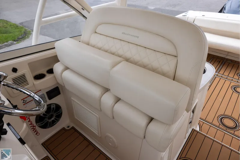 Slide: The Image of 2019 Grady-White Freedom 335 boat interior with luxurious seating and steering wheel. - 18