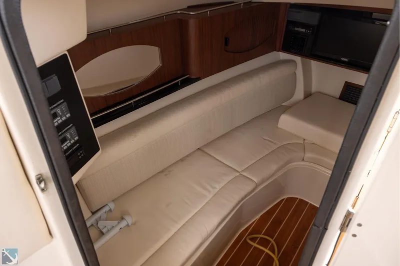 Slide: The Image of 2019 Grady-White Freedom 335 cabin interior with beige seating and wood accents. - 19