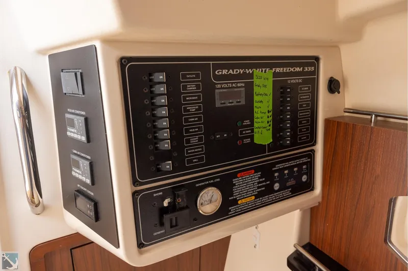 Slide: The Image of Control panel of 2019 Grady-White Freedom 335 boat, featuring switches and gauges. - 20