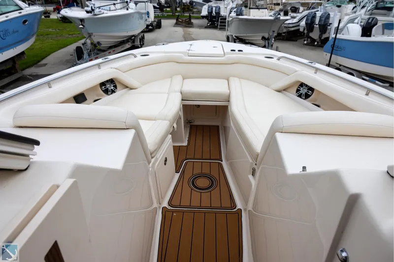 Slide: The Image of 2019 Grady-White Freedom 335 boat interior with cushioned seating and teak flooring. - 21